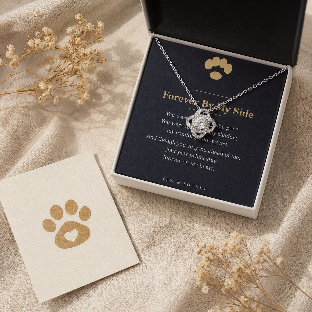 Silver Love Knot pet memorial necklace with keepsake card, styled with dried flowers